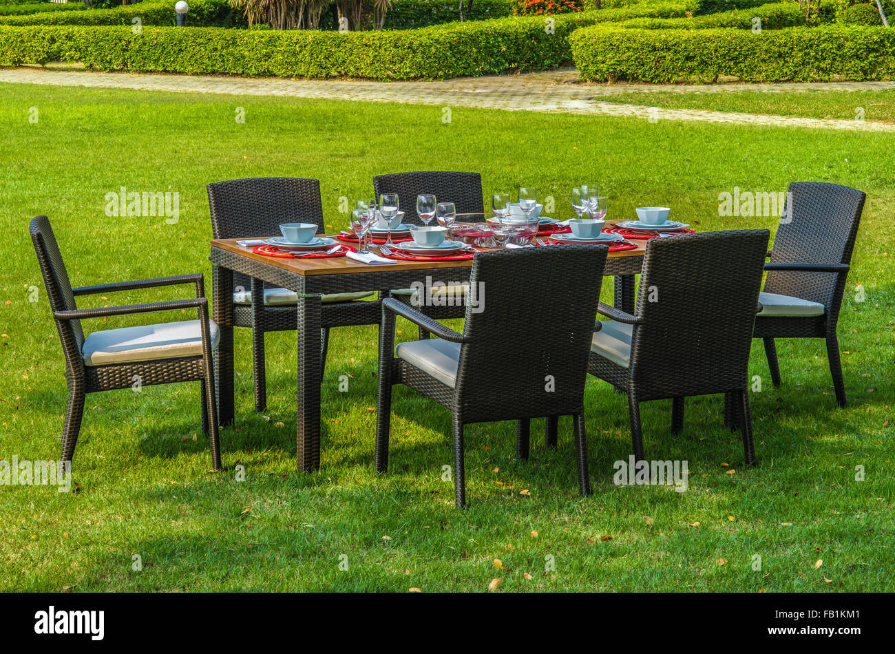 Outdoor rattan furniture, water resistant table, chairs and outdoor cushions Stock Photo