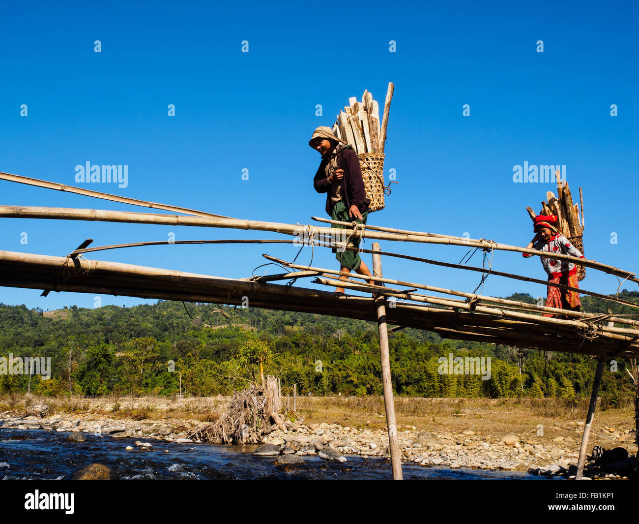 Lisu women carrying firewood collecting from nearby forest. Stock Photo