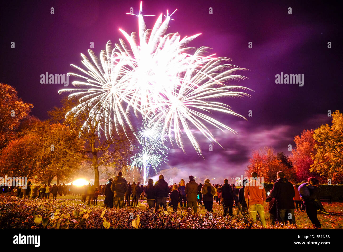 Guy Fawkes night fireworks with a crowd in Elgin, Moray, Scotland, United Kingdom. Stock Photo