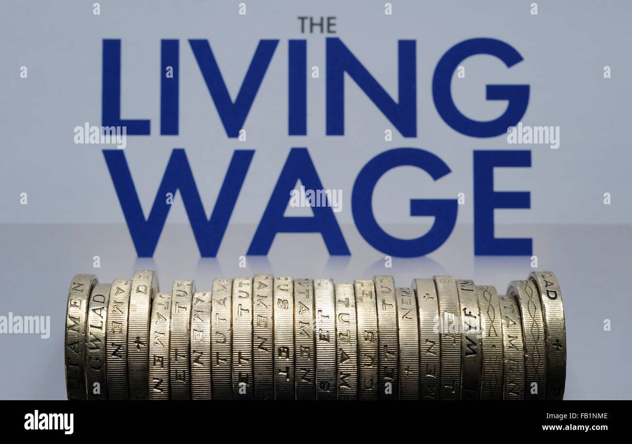 THE LIVING WAGE PROMOTION LEAFLET WITH ONE POUND COINS RE WAGES INCOMES JOB MARKET JOBS EMPLOYMENT MINIMUM EMPLOYERS MONEY UK Stock Photo