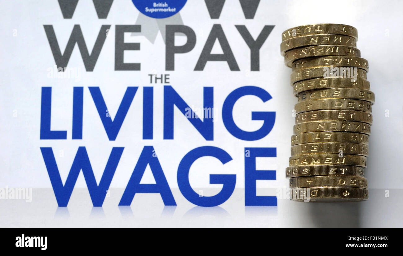 THE LIVING WAGE PROMOTION LEAFLET WITH ONE POUND COINS RE WAGES INCOMES JOB MARKET JOBS EMPLOYMENT MINIMUM EMPLOYERS WAGE UK Stock Photo
