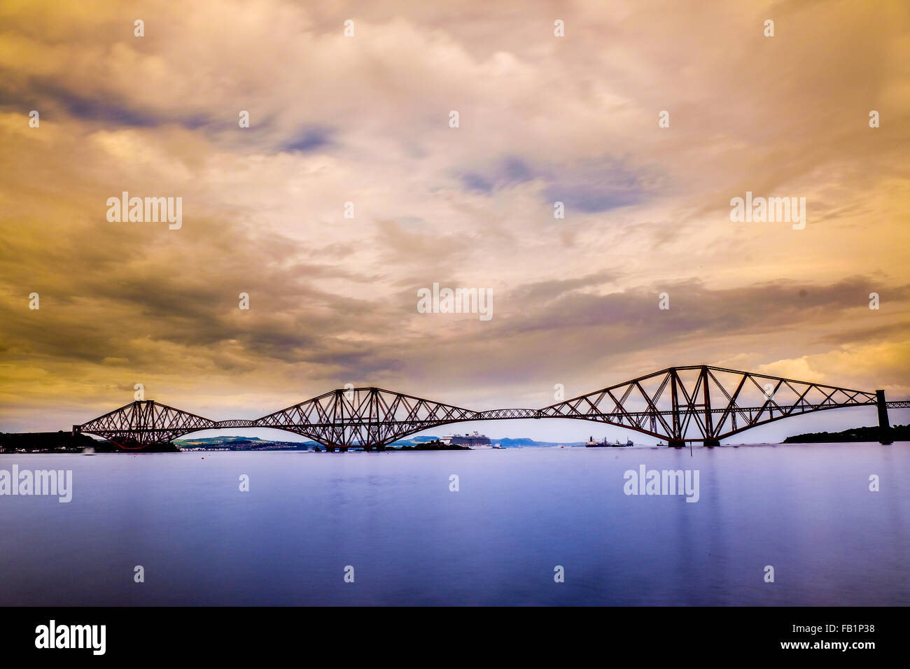 Firth of Forth Train Bridge at sunset in Edinburgh, Scotland, United Kingdom. Stock Photo