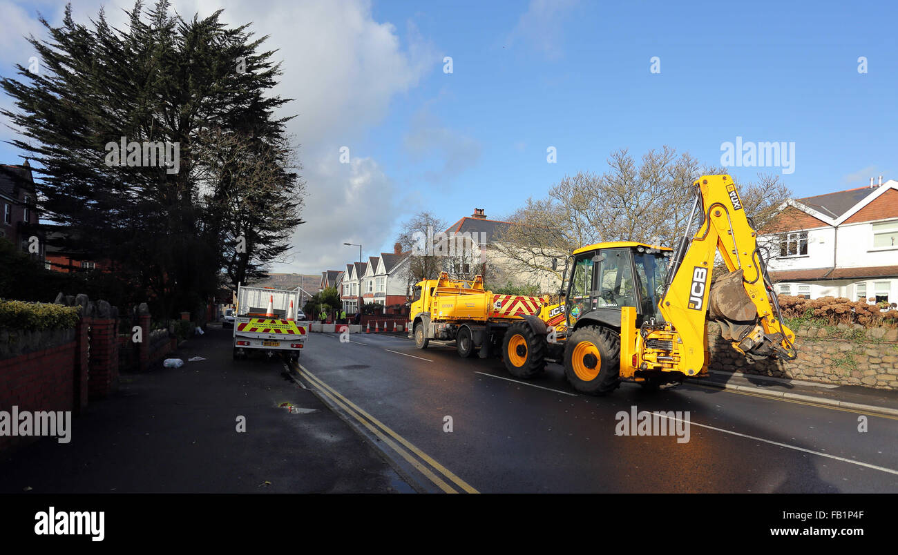 Neath, UK. Thursday 07 January 2016 The scene of the sinkhole in Cimla Road, Neath Re: A sinkhole up to 10ft deep has appeared in Neath. south Wales, leading to the closure of a main road. Police have sealed off Cimla Road, in Neath, following the discovery at the bottom of Cimla Hill. South Wales Police and Neath Port Talbot council workers are currently at the scene assessing the damage and preparing to carry out emergency repairs. Credit:  D Legakis/Alamy Live News Stock Photo