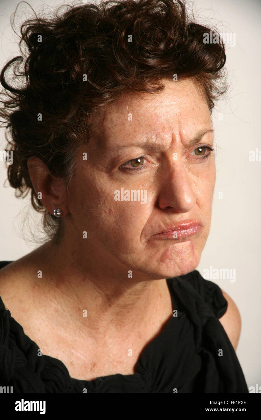 An adult woman imitates the expressions of a baby. Stock Photo