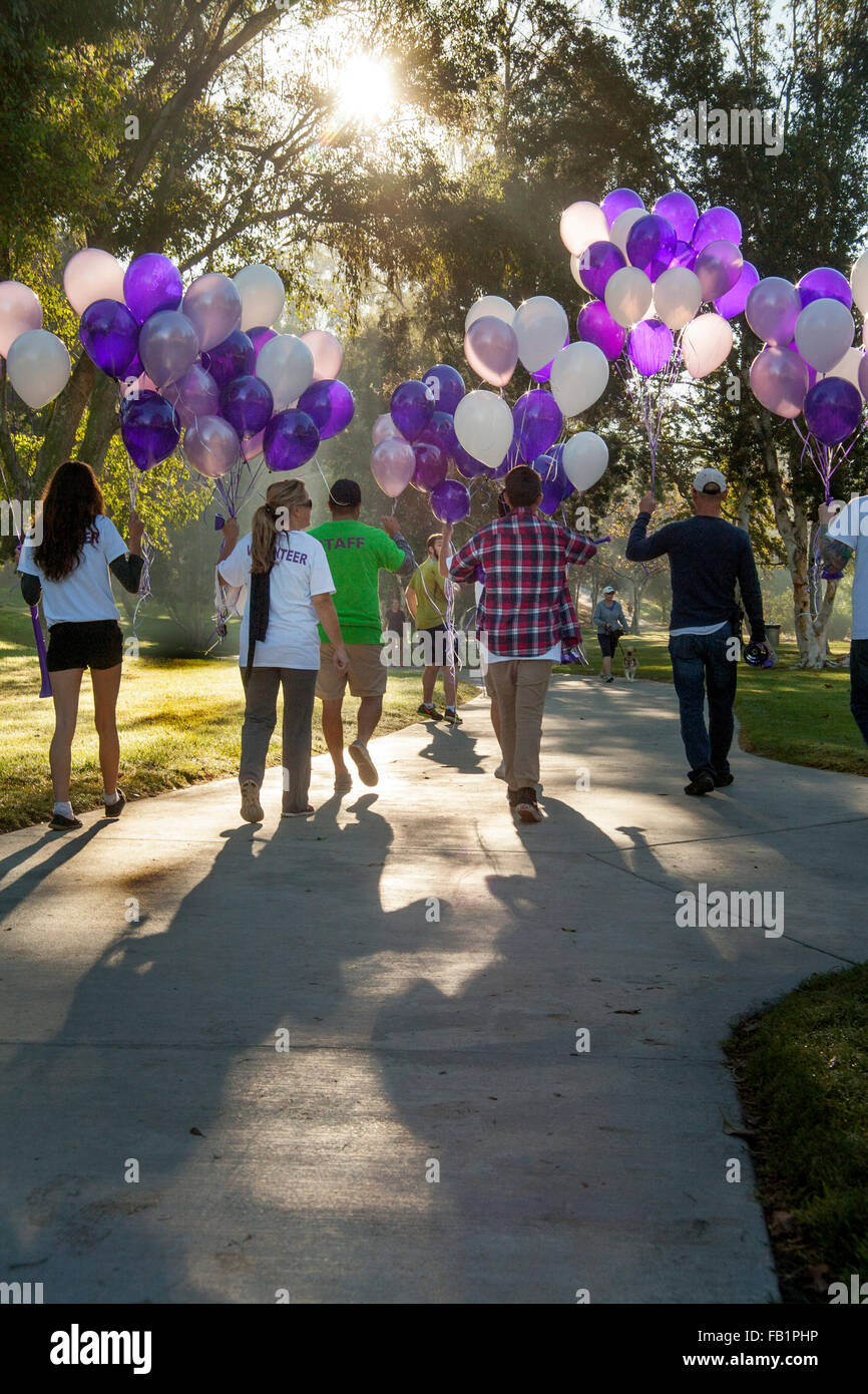 In Bright Morning Sun Multiracial Young Adults Carry Balloons For Use 