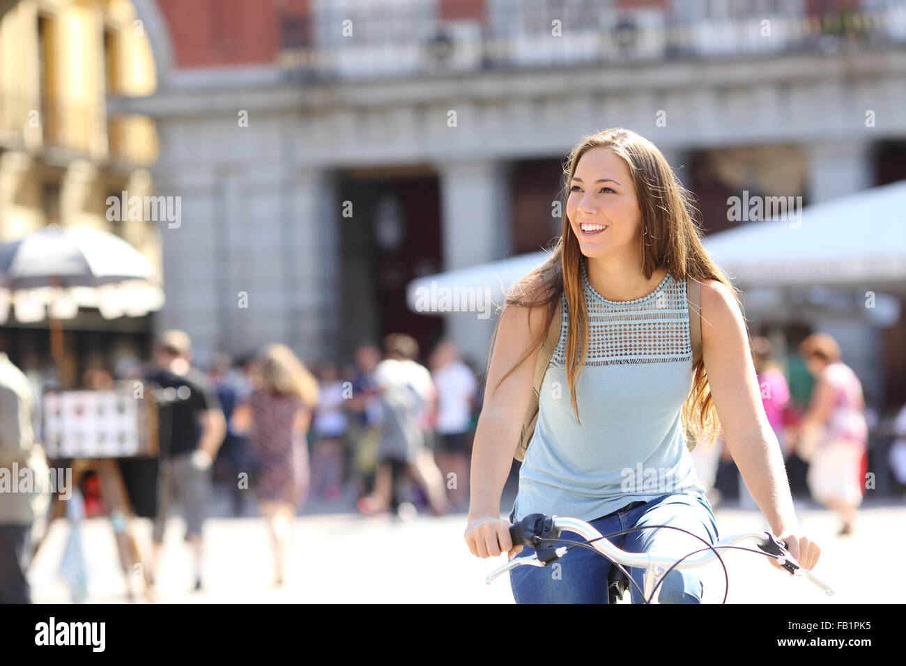 Candid tourist cyclist sightseeing in a old town of a city Stock Photo
