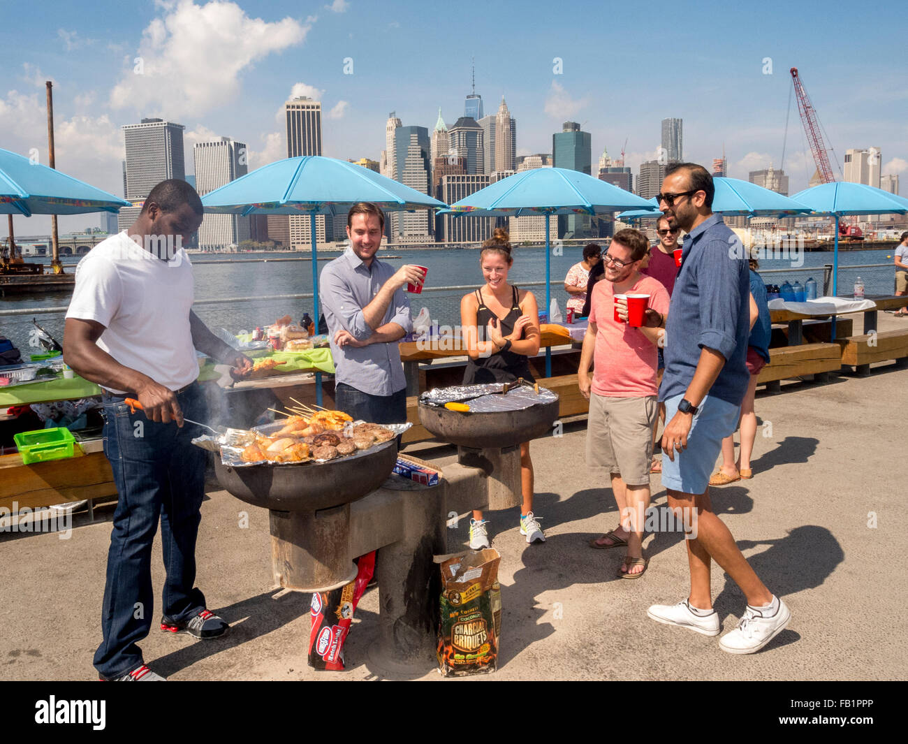 Local residents grill chicken at a picnic in Brooklyn Bridge Park in