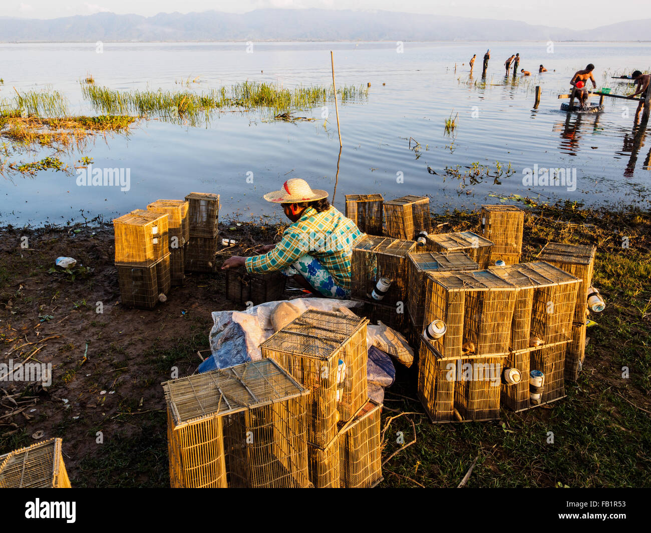 A local woman preparing fishing tool on the lake side. Stock Photo