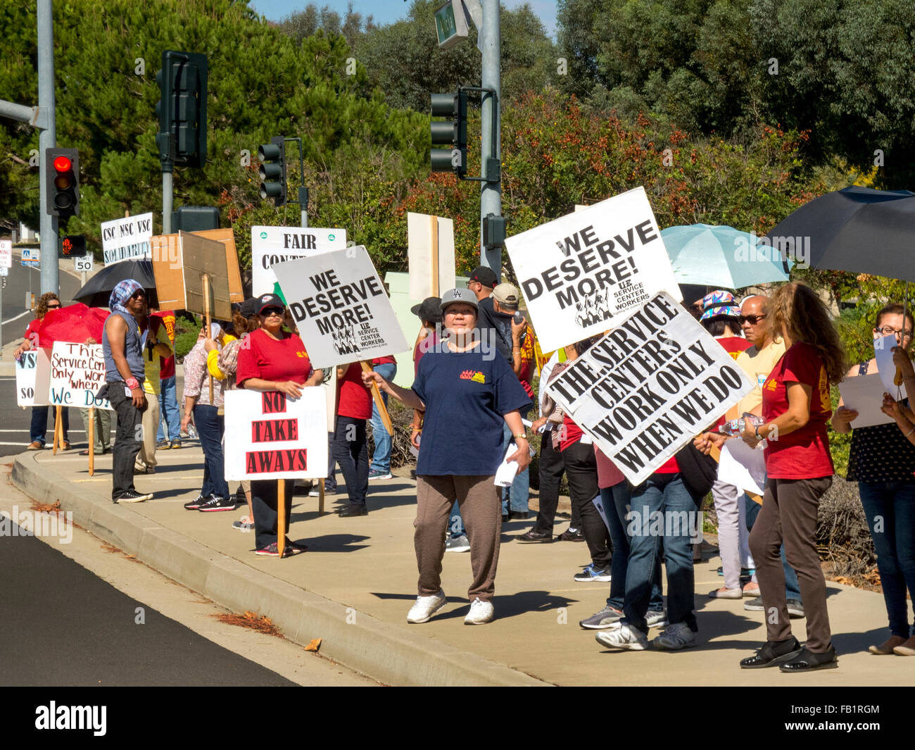 Multiracial striking electrical union workers picket a US Government building in Laguna Niguel, CA, protesting lack of scheduled salary increases. Stock Photo