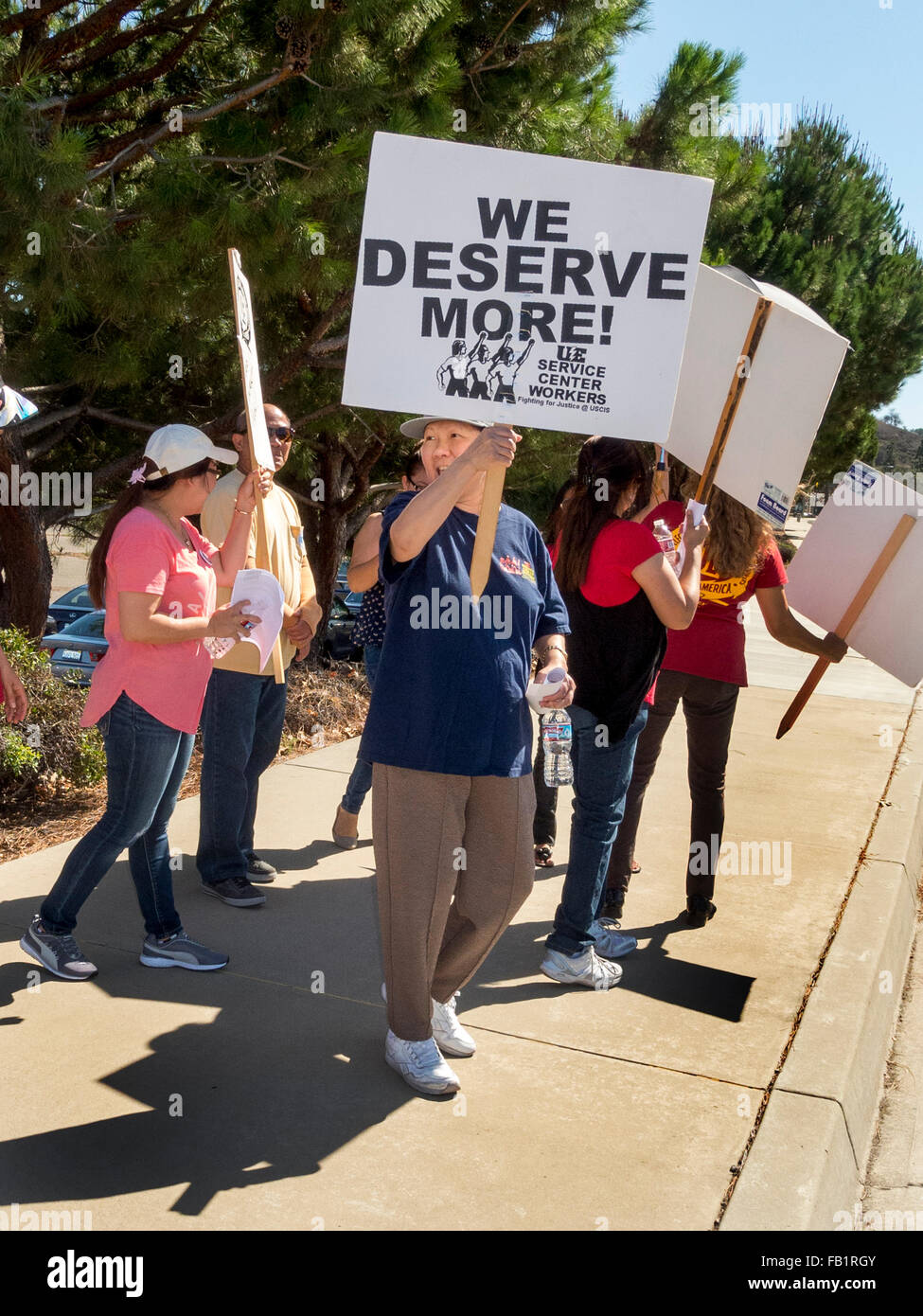 Multiracial striking electrical union workers picket a US Government building in Laguna Niguel, CA, protesting lack of scheduled salary increases. Stock Photo