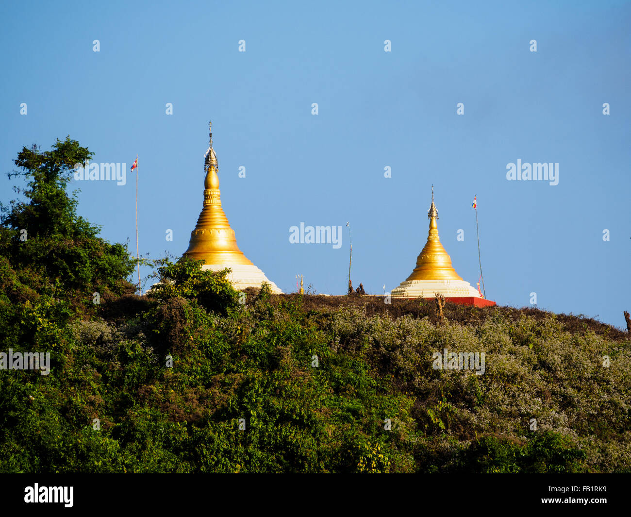 Two golden pagodas on the hill over Indawgyi lake Stock Photo