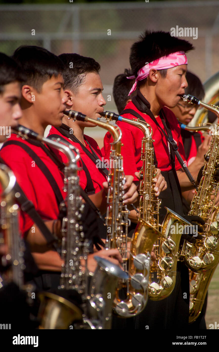 Uniformed Vietnamese American high school marching band saxophone