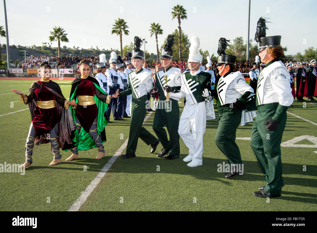 Happy winning multiracial high school marching band members in uniform