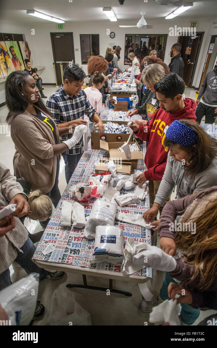 Multiracial young adult volunteers assemble hygiene kits for the
