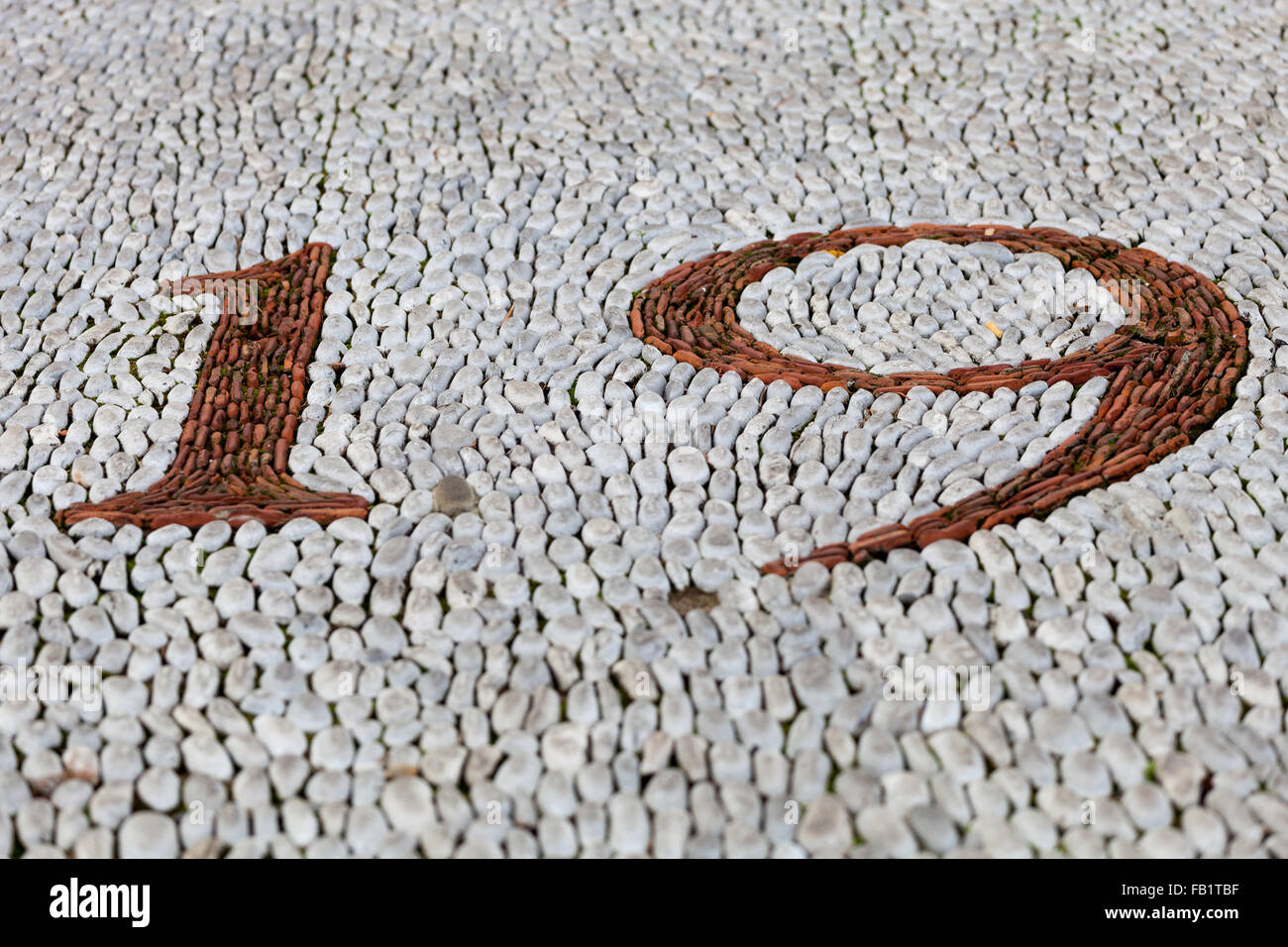 Number 19 made up of stones to make a mosaic pattern in the ground. Stock Photo