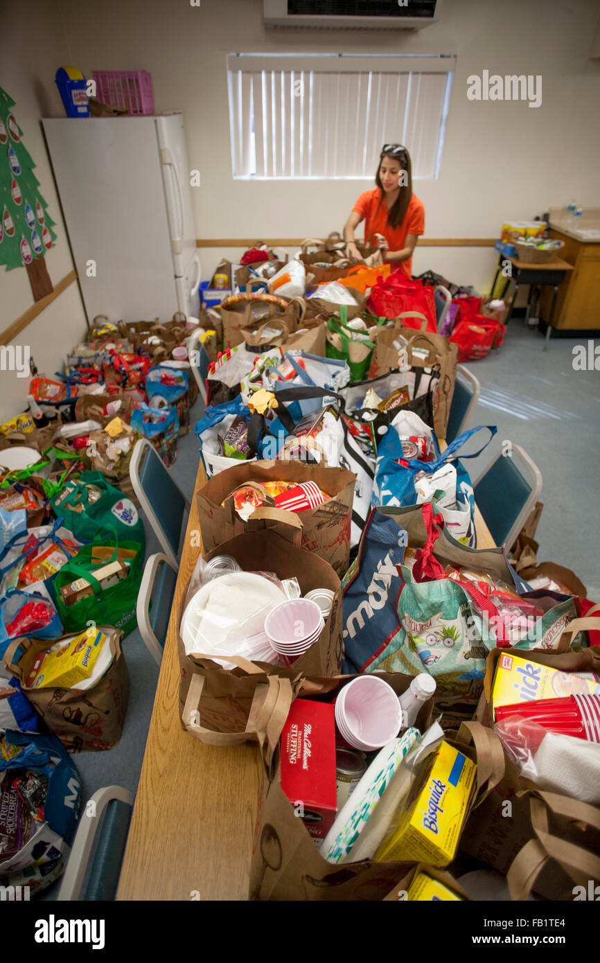 A pile of donated Thanksgiving toys for local Hispanic children is organized by a volunteer at an Anaheim, CA, community center. Stock Photo