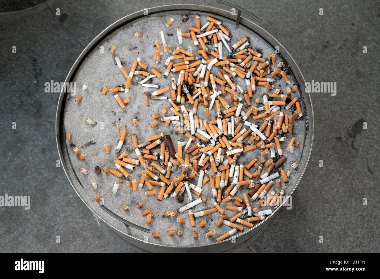 A cigarette butt filled sand bucket outside offices in the la Défense