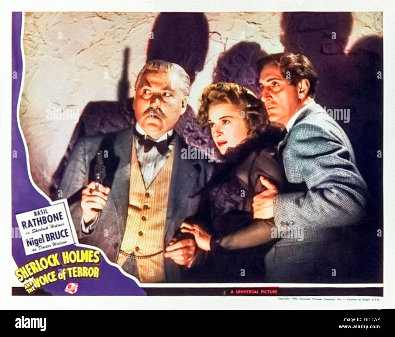 Lobby card for 'Sherlock Holmes and the Voice of Terror' 1942  film directed by John Rawlins and starring Basil Rathbone (Holmes); Nigel Bruce (Watson) and Evelyn Ankers (Kitty). See description for more information. Stock Photo
