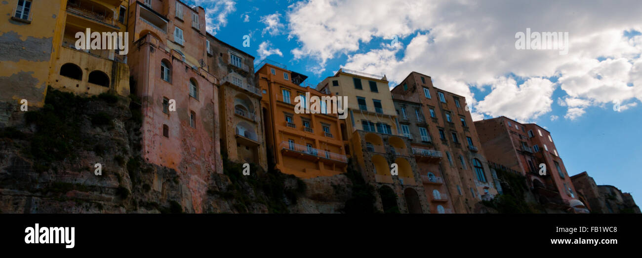 Colorful houses under blue sky with cloud sitting on cliff of Tropea coast Stock Photo