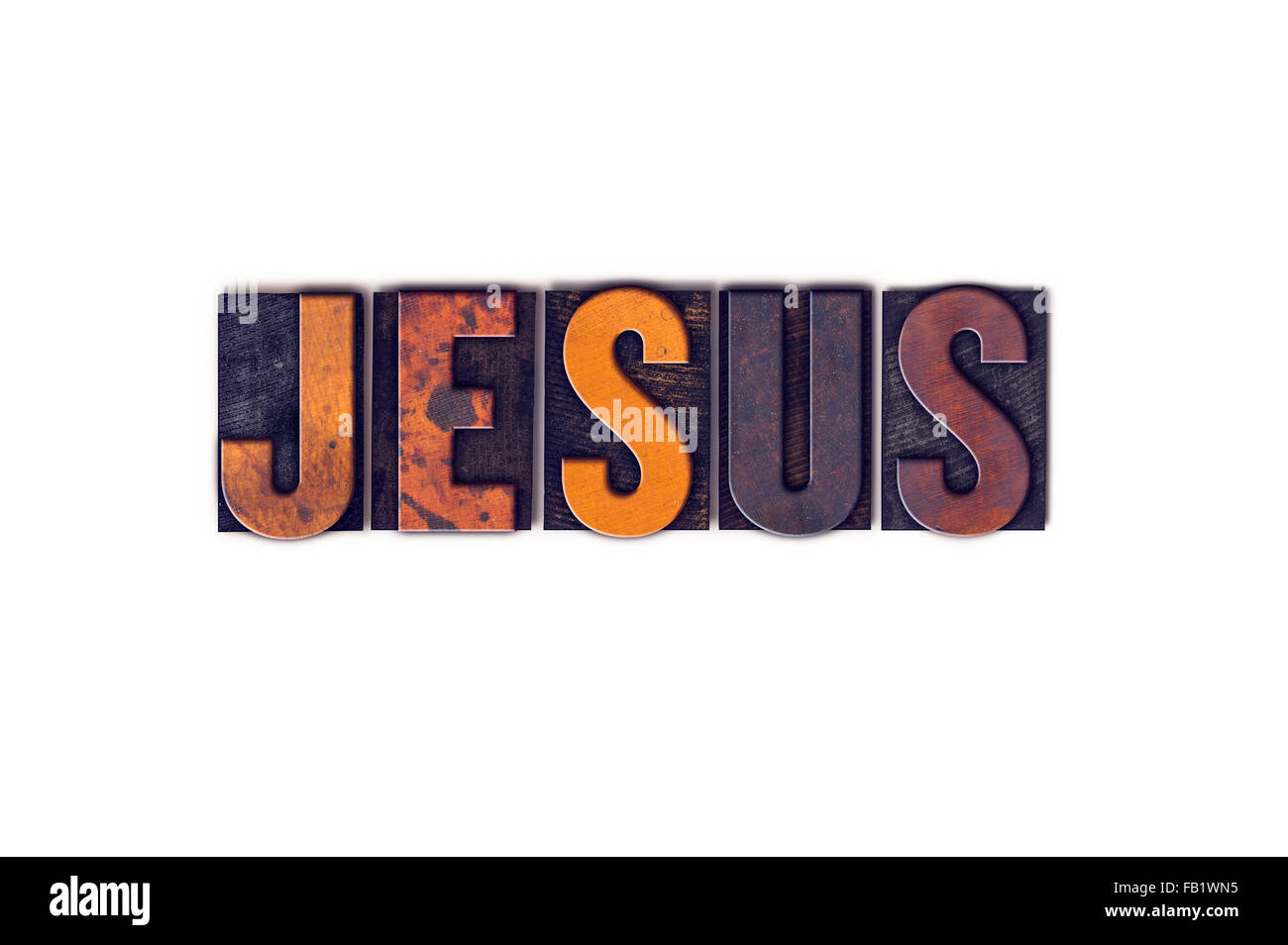 The word "Jesus" written in isolated vintage wooden letterpress type on a white background. Stock Photo