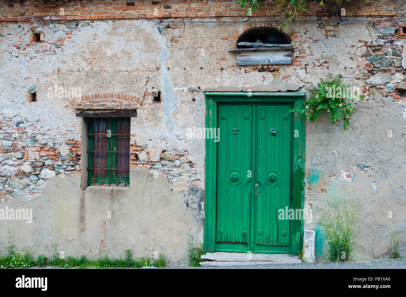 Old italian stone house front with green door Stock Photo Alamy