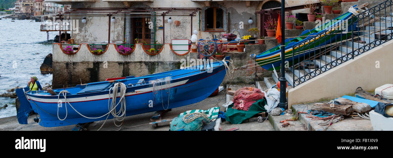 Two blue and green boats sitting on land in small italian town Scilla Stock Photo