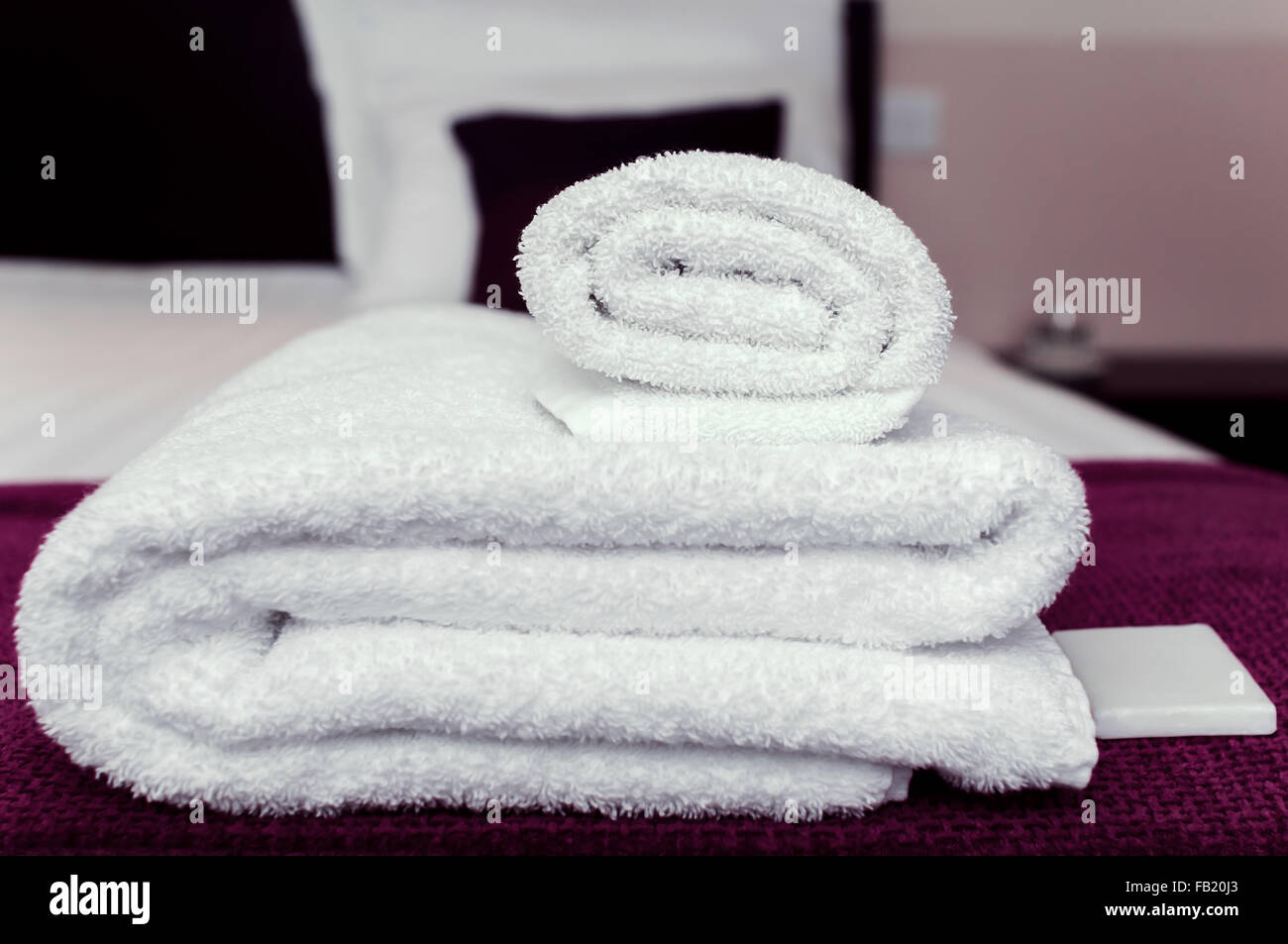 Closeup clean towels and soap in hotel room hygiene and hospitality concept Stock Photo