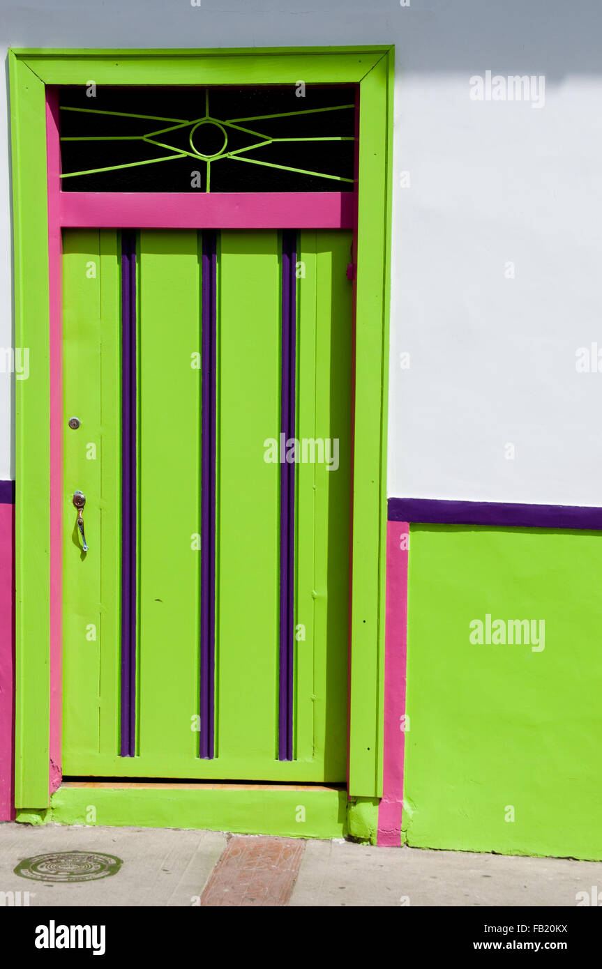Green pink wooden door of a colonial house front Stock Photo