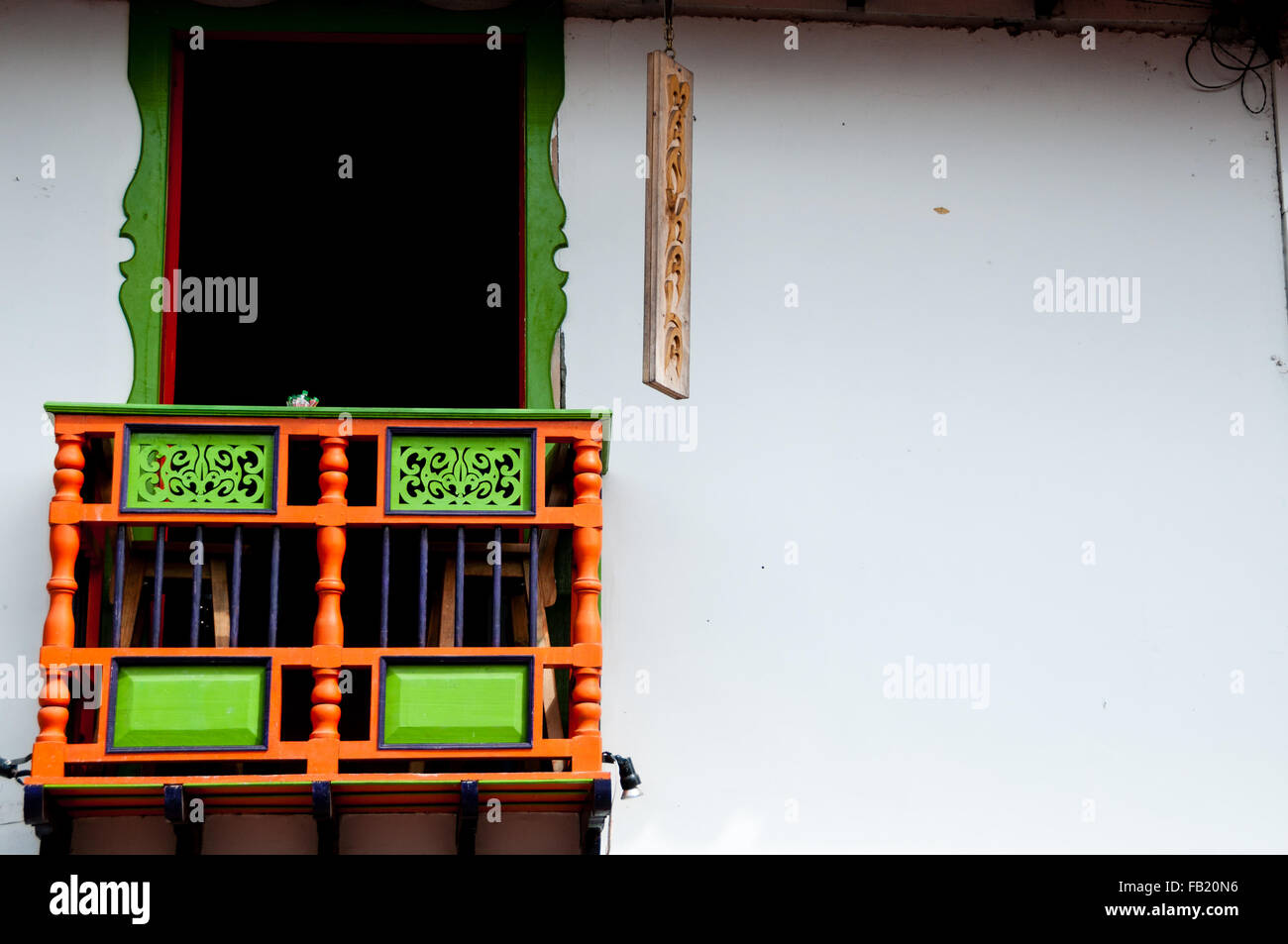 Colorful green and red house front with balcony in Salento Stock Photo