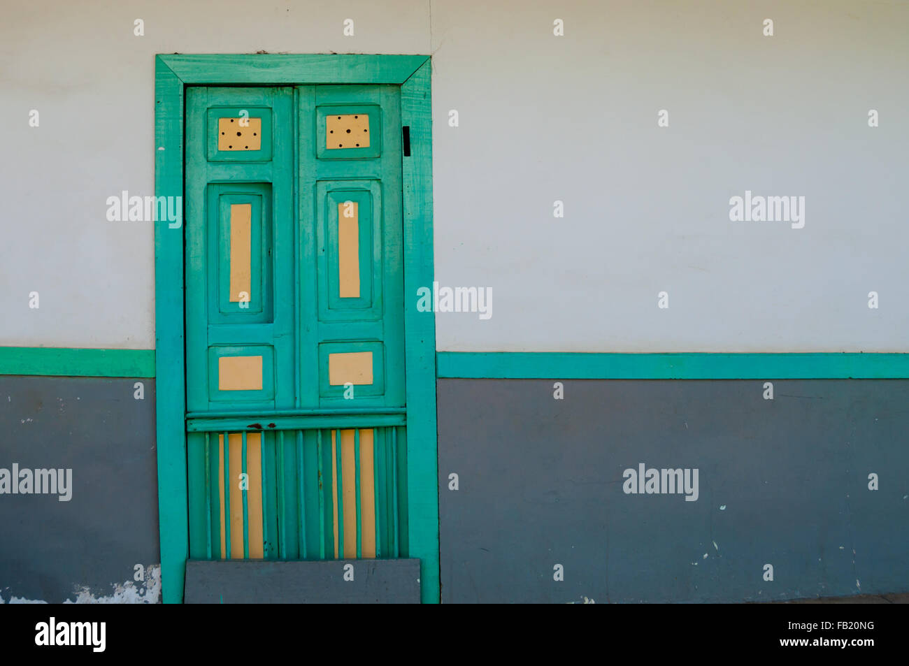 Yellow turquoise green wooden door of a colonial house front Stock ...
