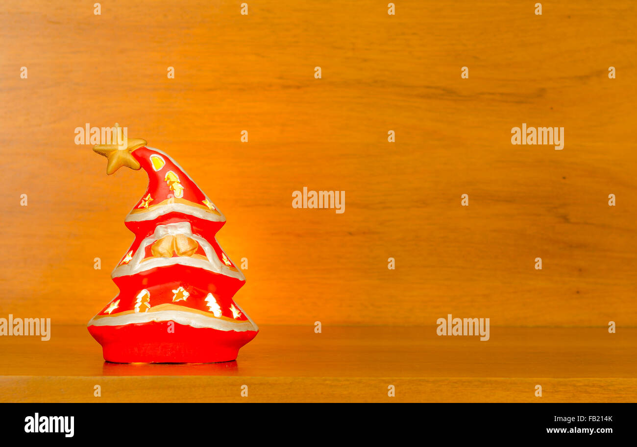 A softly glowing Christmas tree on a wooden background Stock Photo - Alamy