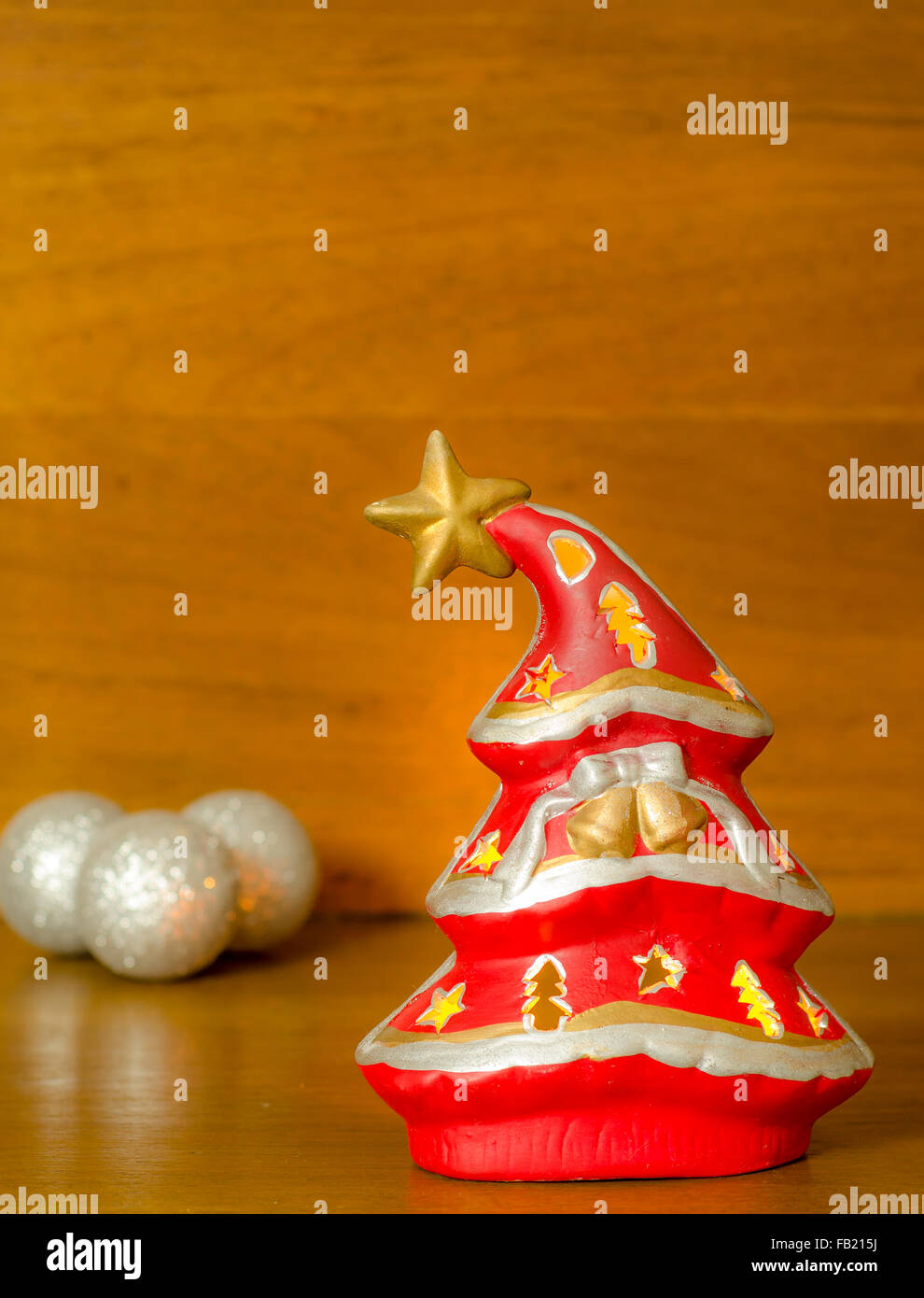 A softly glowing Christmas tree on a wooden background Stock Photo - Alamy