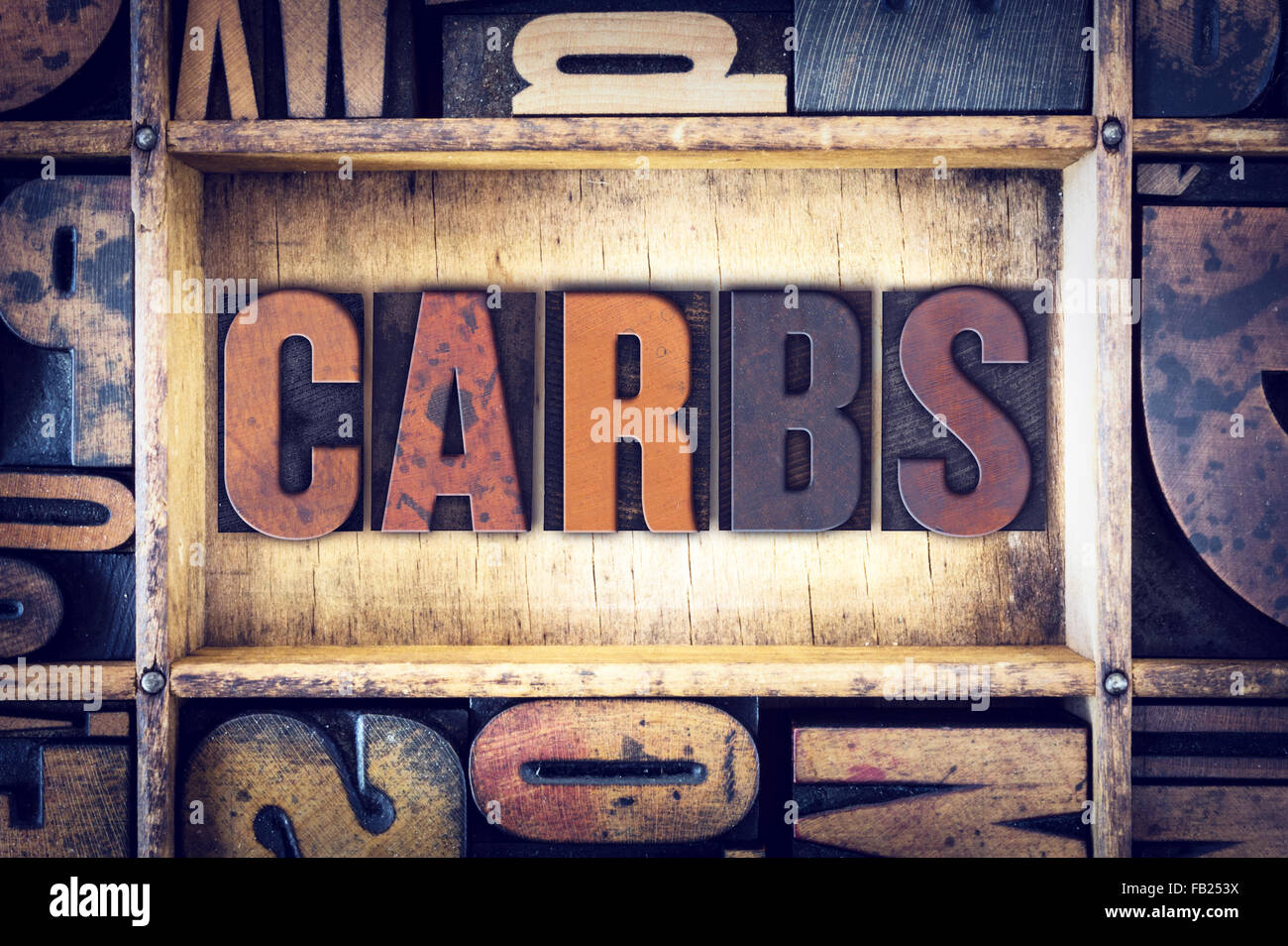 The word "Carbs" written in vintage wooden letterpress type. Stock Photo