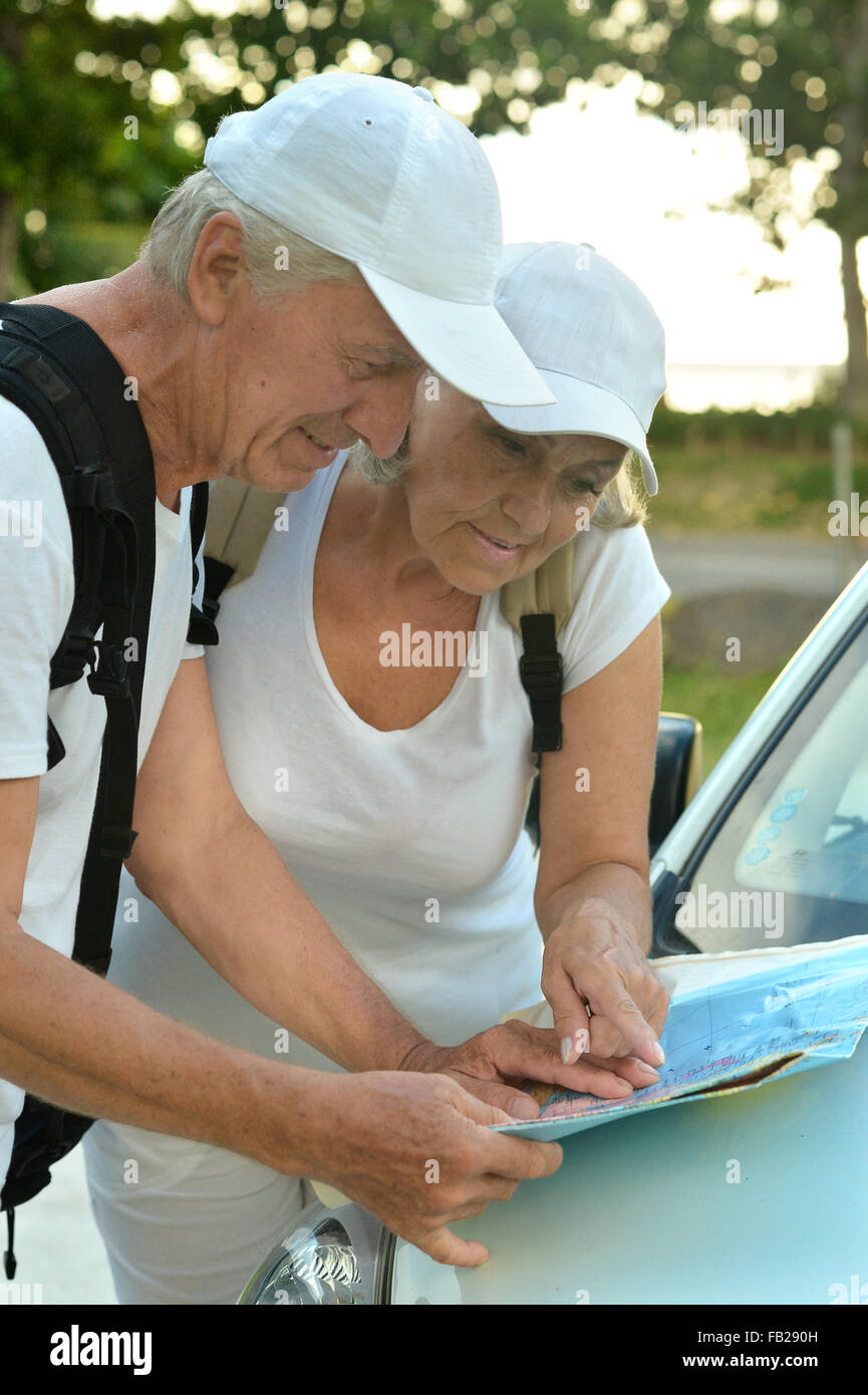 Elderly couple looking at travel map Stock Photo