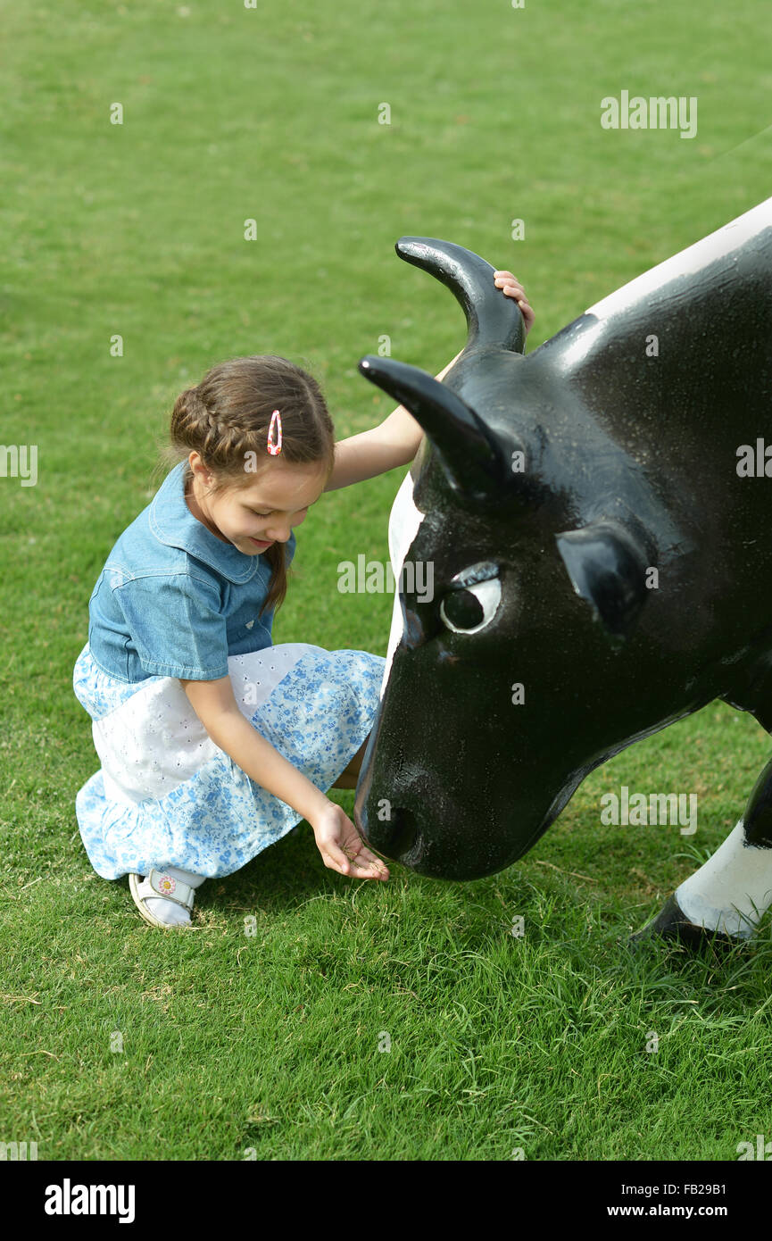 Little girl and cow Stock Photo - Alamy