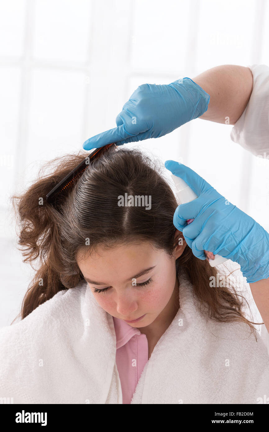 Mother combing daughter Stock Photo