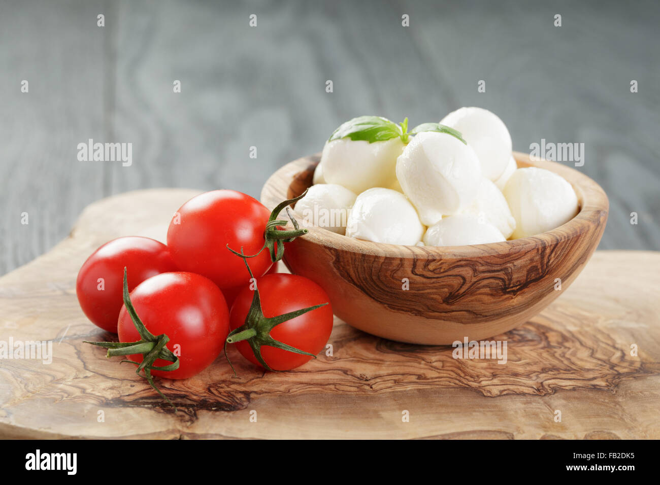 Tomato and mozzarella with basil leaves in bow Stock Photo - Alamy