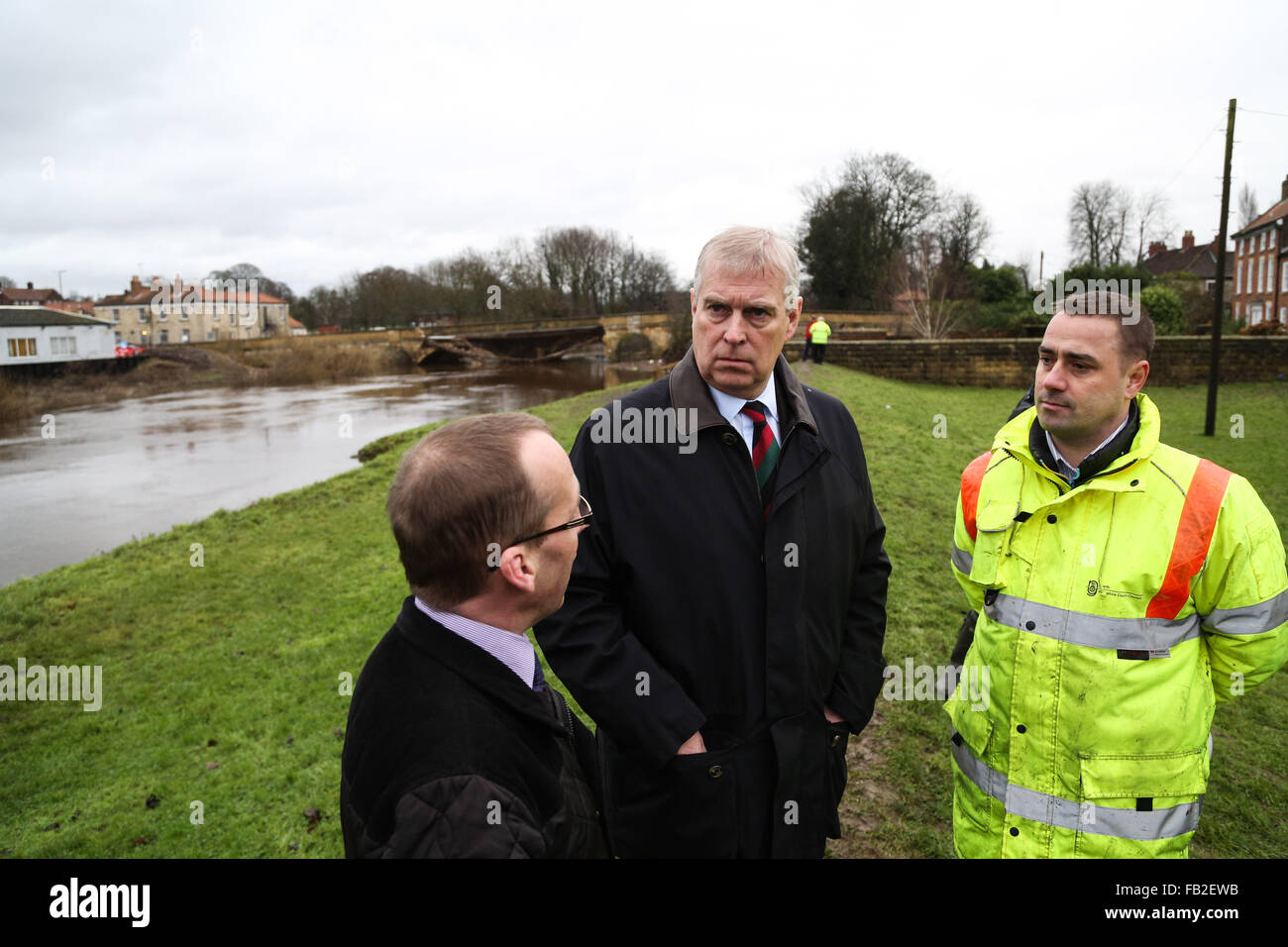 Prince Andrew, The Duke of York, (centre) talks to Councillor Richard Sweeting, Cjairman of Selby District Council, (left) and Andrew Wood, Senior Engineer At North Yorkshire County Council, (right), during a visit to the town of Tadcaster in North Yorkshire to see the damage caused by flooding in the last month. The town was heavily affected after the River Wharfe burst it's banks causing the bridge to partially collapse. Credit:  Ian Hinchliffe/Alamy Live News Stock Photo