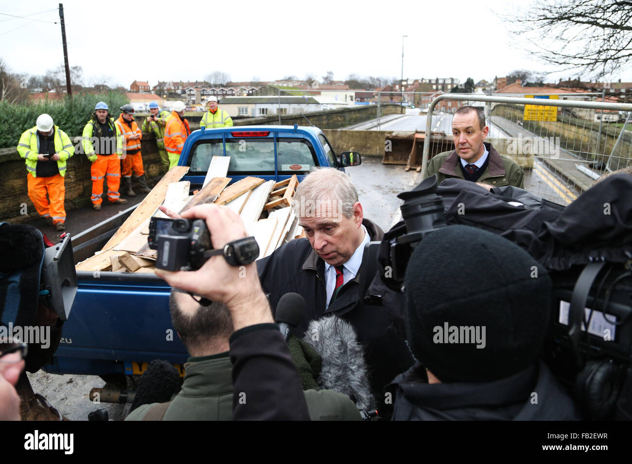 Prince Andrew, The Duke of York, talks to the media in front of Tadcaster Bridge during a visit to the town of Tadcaster in North Yorkshire to see the damage caused by flooding in the last month. The town was heavily affected after the River Wharfe burst it's banks causing the bridge to partially collapse. Credit:  Ian Hinchliffe/Alamy Live News Stock Photo