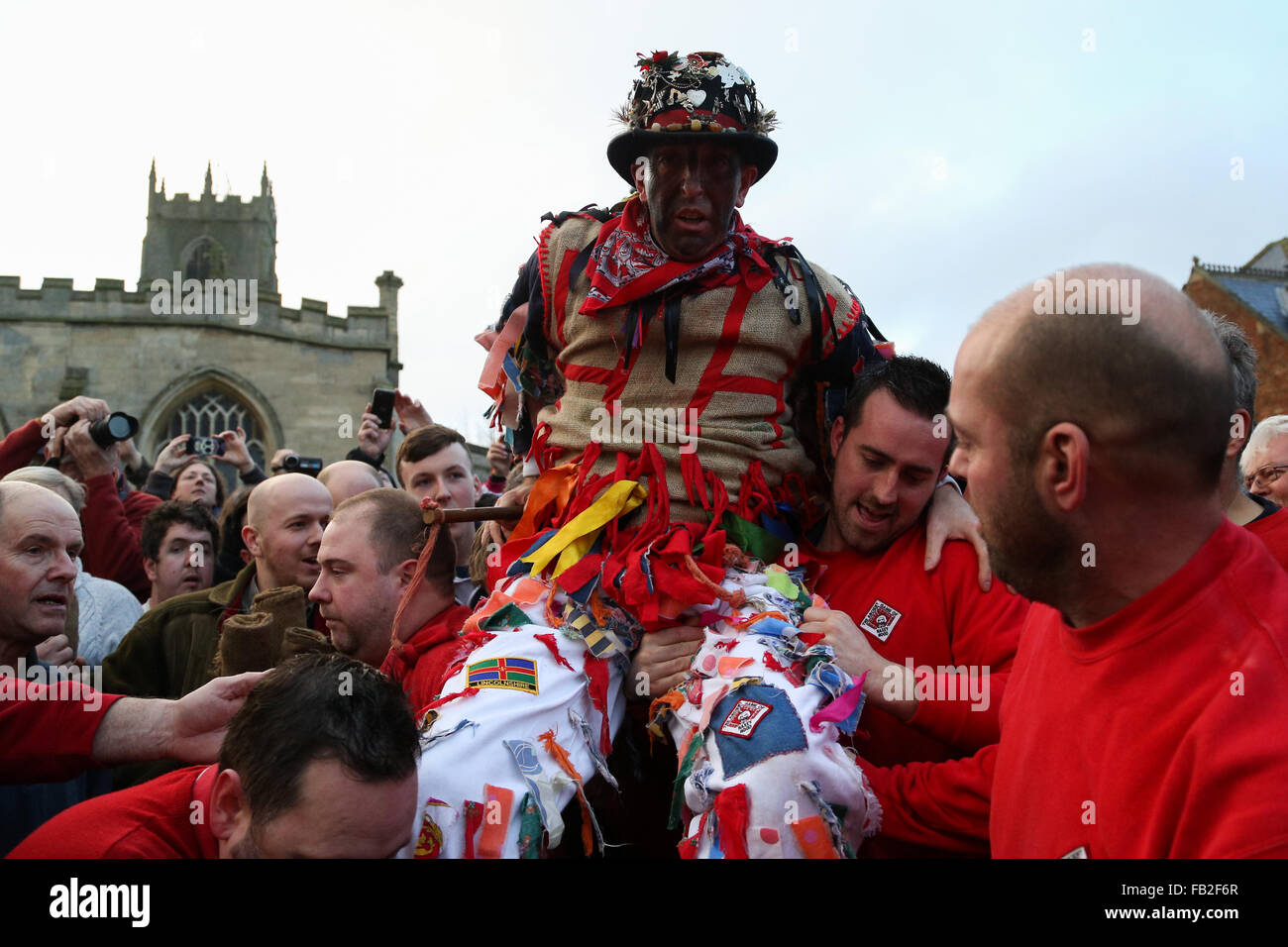 The fool is carried to the mounting block ready to make his speech and then be 'smoked' before the start of the 2016 Haxey Hood. Stock Photo