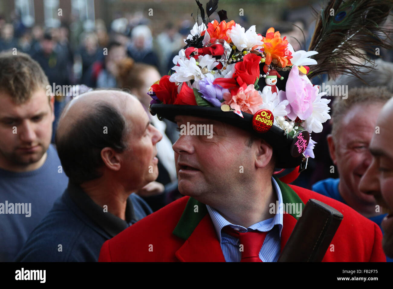 A man wearing tradition costume makes his way through the crowd during the Haxey Hood. Held annually in the small village of Hax Stock Photo