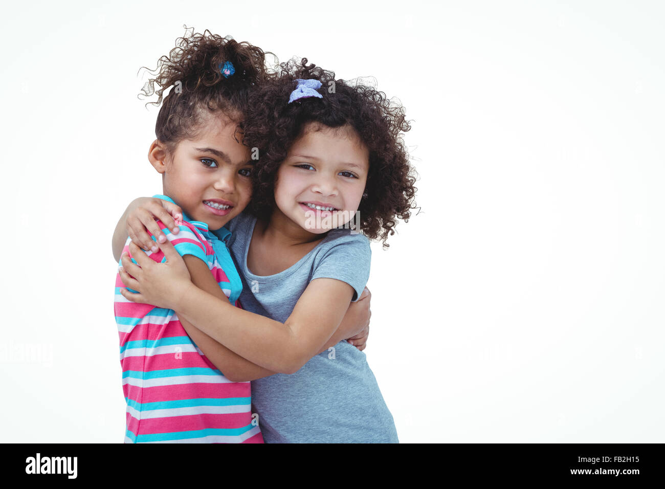 Cute girls hugging and looking at camera Stock Photo - Alamy