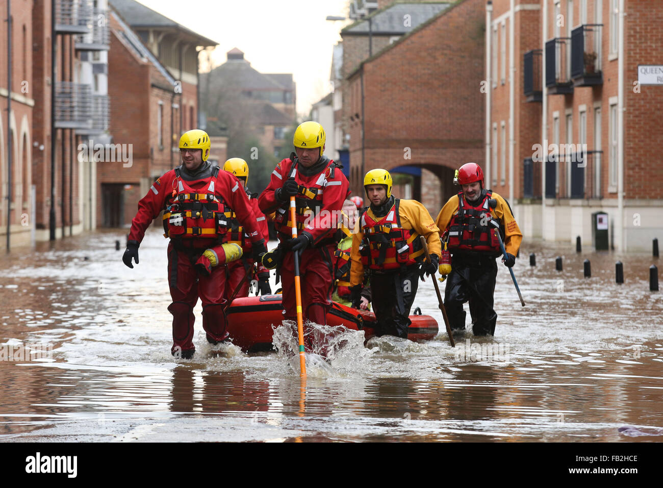 Rescue workers wade through high flood water in York, Yorkshire, UK, after both the River Ouse and Foss burst their banks. Stock Photo