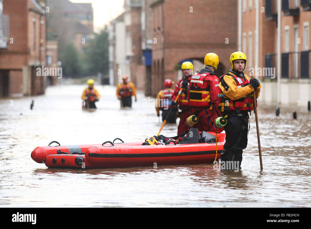 Rescue workers wade through high flood water in York, Yorkshire, UK, after both the River Ouse and Foss burst their banks. Stock Photo