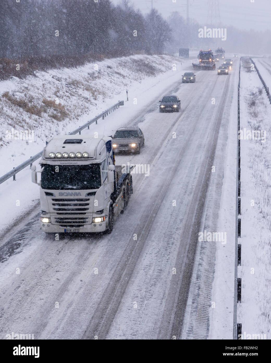 Sweden Weather: E20, Floda, Sweden, 8th Feb 2016. First major snowfall of the year causes traffic accidents and widespread travel disruptions. Snowplows and gritters are deployed to keep E20 motorway open.  Model Release: No.  Property Release: No. Stock Photo