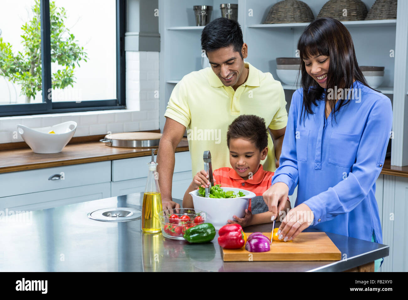 Happy Family Preparing Salad In The Kitchen Stock Photo Alamy