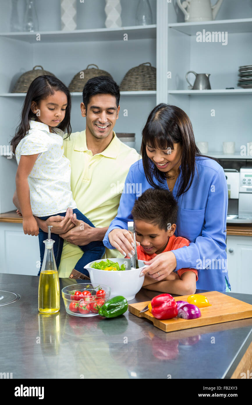 Happy family preparing salad in the kitchen Stock Photo Alamy