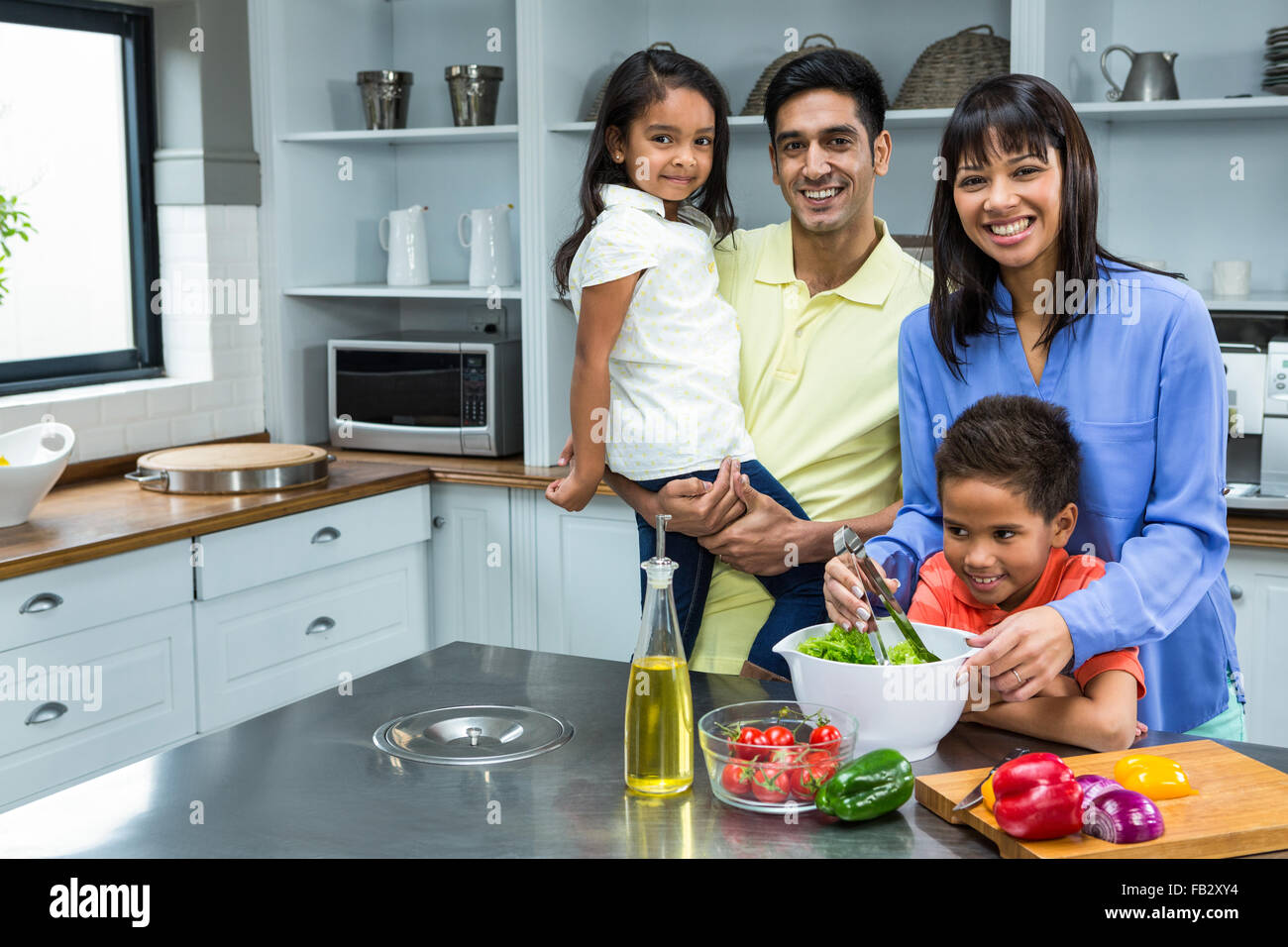 Happy family preparing salad in the kitchen Stock Photo Alamy