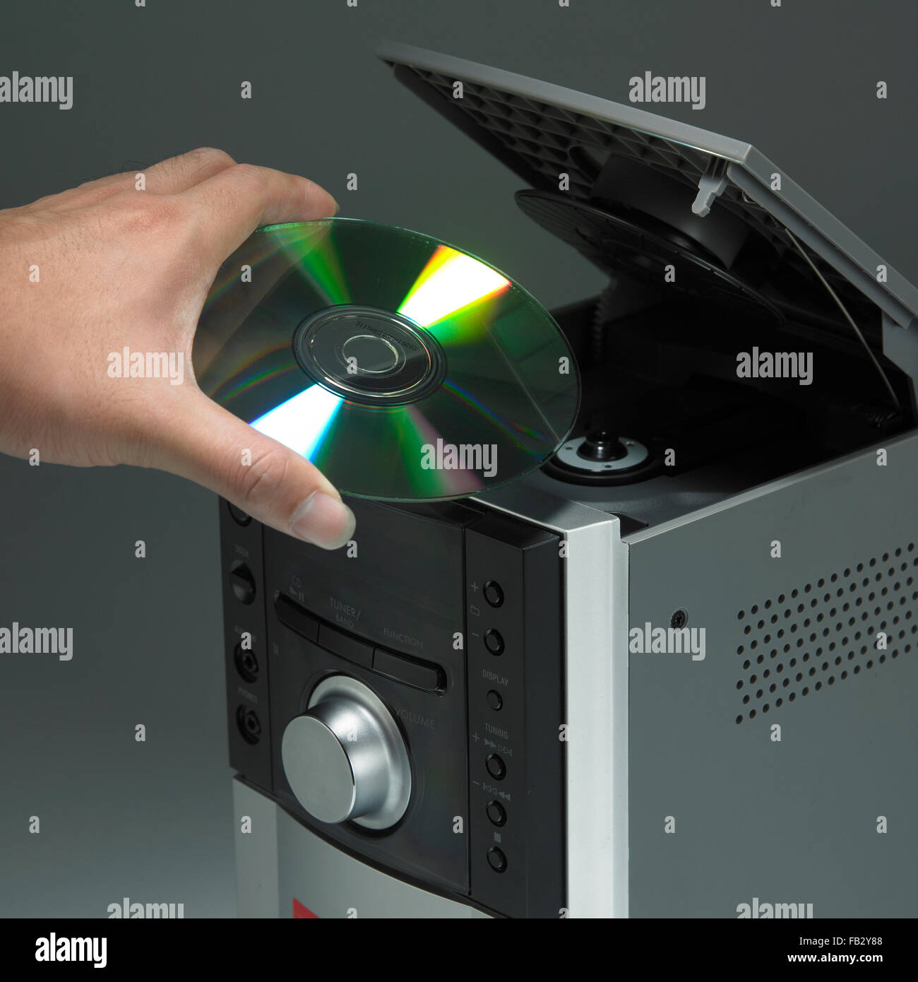 hand putting cd into cd player Stock Photo Alamy