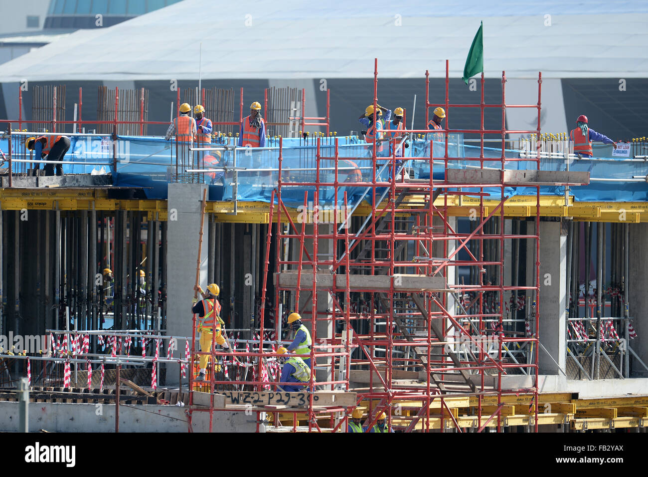 Doha, Qatar. 07th Jan, 2016. Construction workers work on a building